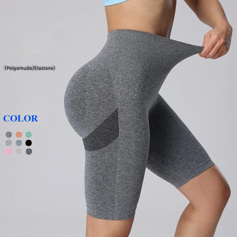 High-waisted gray seamless athletic shorts with a wide waistband and subtle side contour accents.