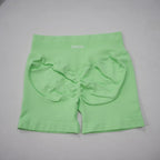 Seamless high-waisted gym shorts in vibrant mint green with a scrunch-butt design and wide waistband for tummy control.
