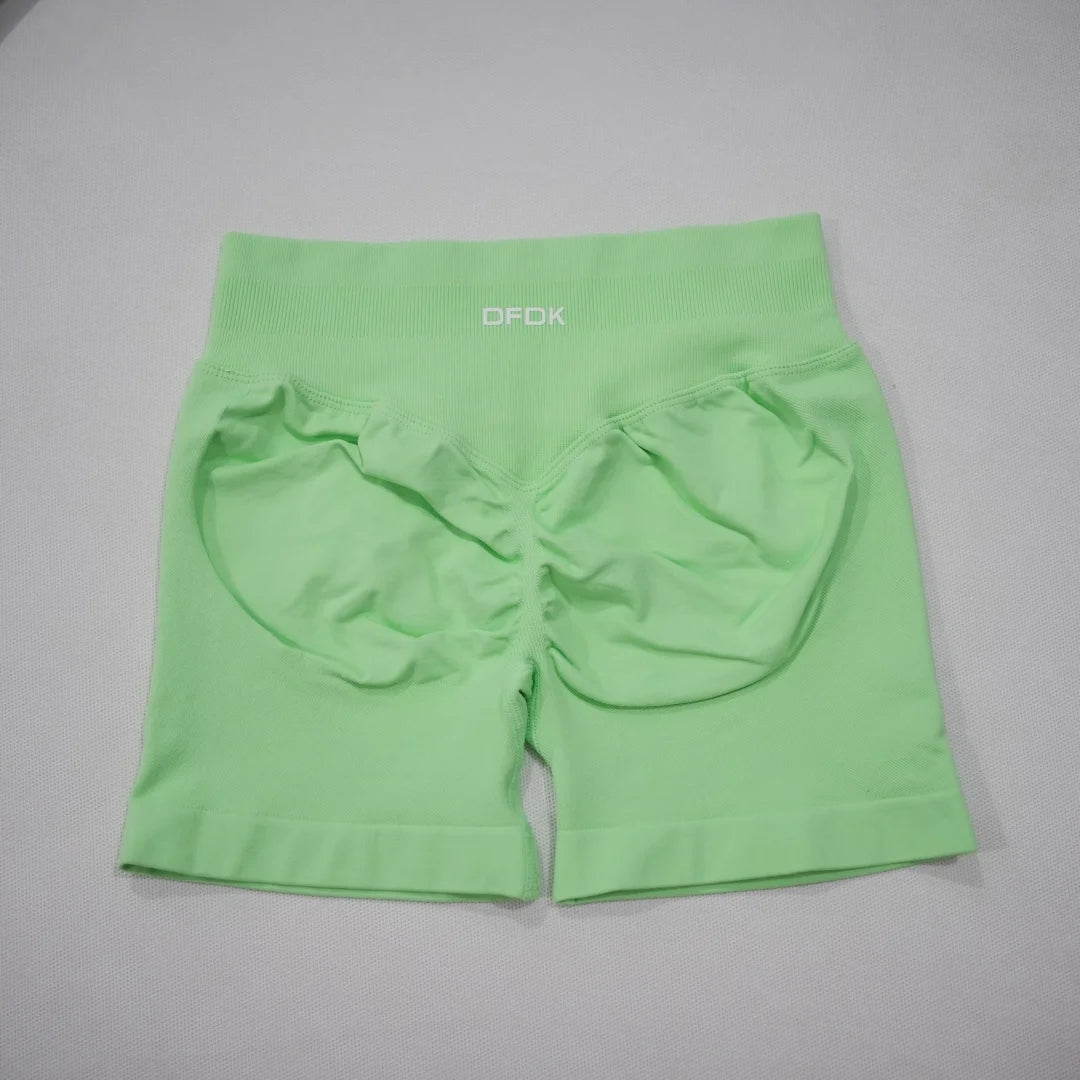 Seamless high-waisted gym shorts in vibrant mint green with a scrunch-butt design and wide waistband for tummy control.