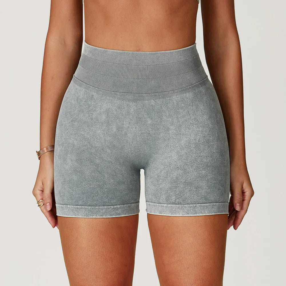High-waisted gray seamless gym shorts with a sand-washed texture and thick waistband, designed for comfort and support.
