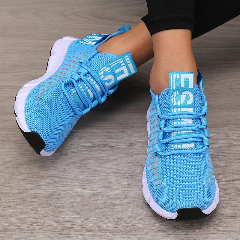 Blue knitted performance sneakers with breathable mesh, secure lace-up design, and lightweight outsole.
