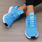 Blue knitted performance sneakers with breathable mesh, secure lace-up design, and lightweight outsole.
