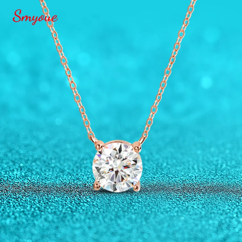 Round-cut Moissanite pendant necklace in rose gold setting, featuring a delicate chain against a sparkling turquoise background.