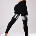 High-rise black leggings with white varsity stripes on the thighs and a deep V-back design, showcasing a sleek silhouette.