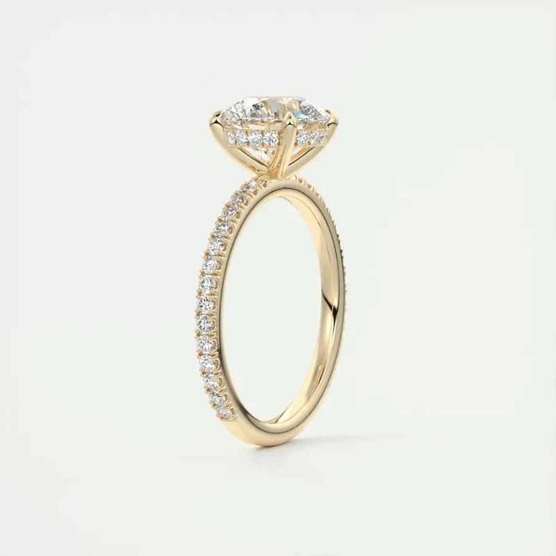 Elegant 2 carat round-cut Moissanite ring in a polished yellow gold setting with a sparkling band of smaller stones.
