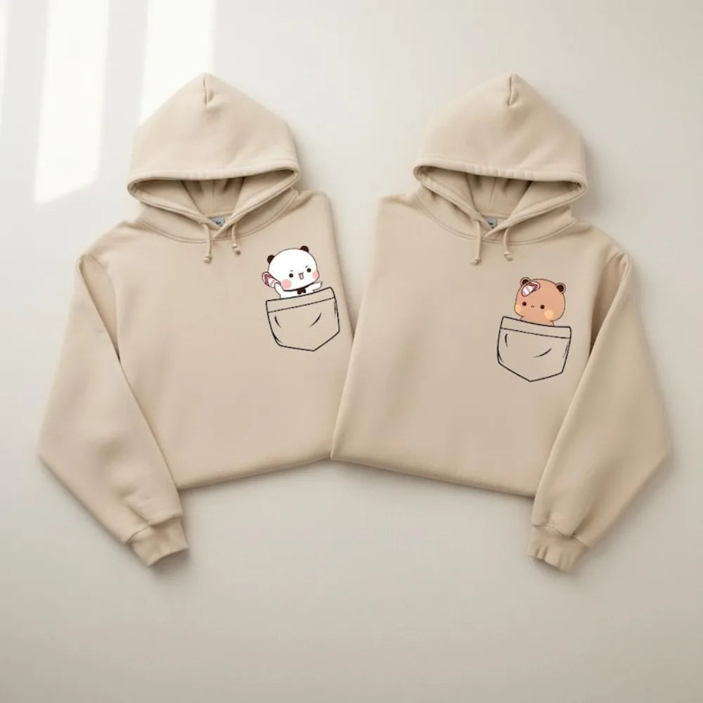 Beige oversized hoodie featuring cartoon bears peeking from pockets, with a soft fabric and relaxed fit.