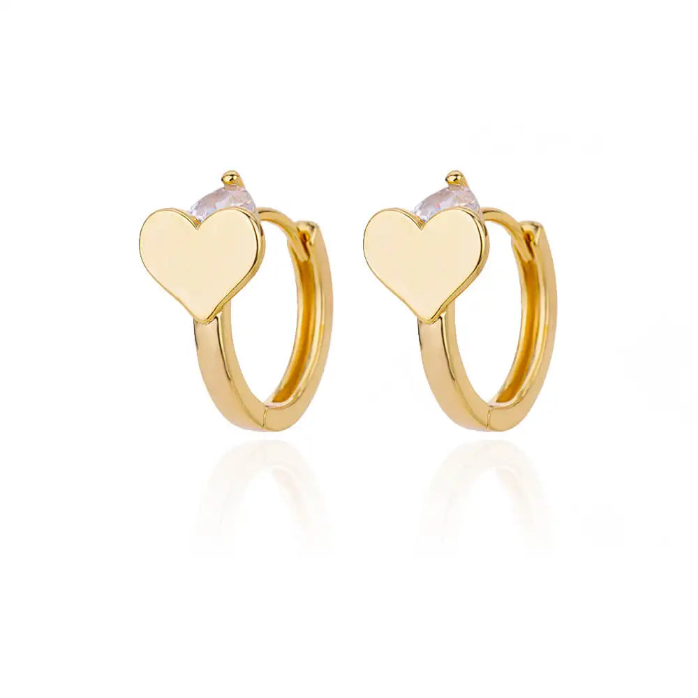 Chunky gold huggie earrings feature a heart drop design with a smooth finish and a secure snap-lock closure.