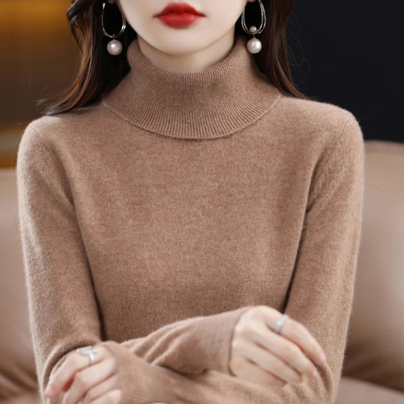 Premium merino wool and cashmere turtleneck sweater in a warm tan color, featuring a relaxed high collar and ribbed trims.