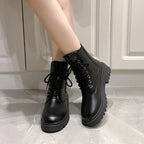 Black Chelsea boots with chunky block heels, featuring a sleek, smooth upper and front lace-up detail.