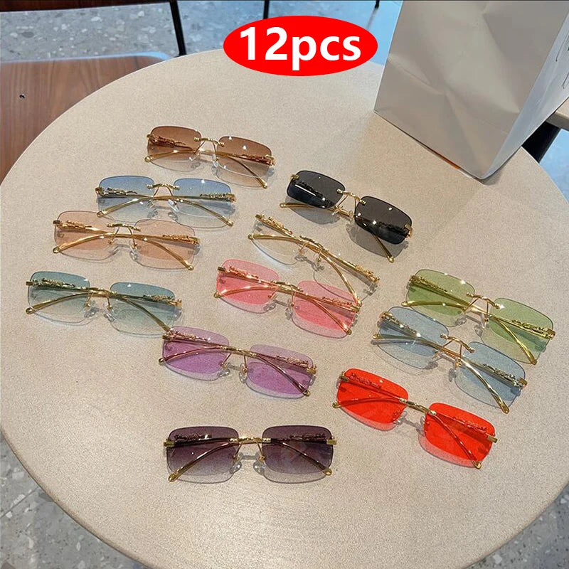 Rimless Y2K rectangle sunglasses in assorted colors, featuring narrow gradient lenses and metallic accents, displayed on a table.