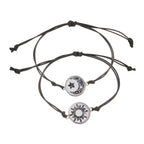 Two matching glow-in-the-dark bracelets with minimalist rope chains, featuring a moon and sun emblem on each.