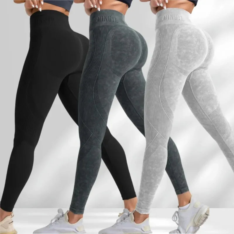 High-waisted seamless leggings in black, dark grey, and light grey with a sand-washed texture and ribbed design.