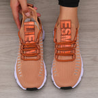 Knitted performance sneakers in a peach color with a breathable mesh upper, featuring a lace-up system and a lightweight outsole.