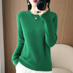 Cozy green ribbed pullover with a crewneck collar, worn by a model, showcasing long sleeves and a relaxed fit.