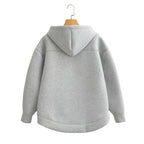 Oversized gray hoodie with a double-layered hood and ribbed cuffs, showcasing a relaxed drop-shoulder fit.