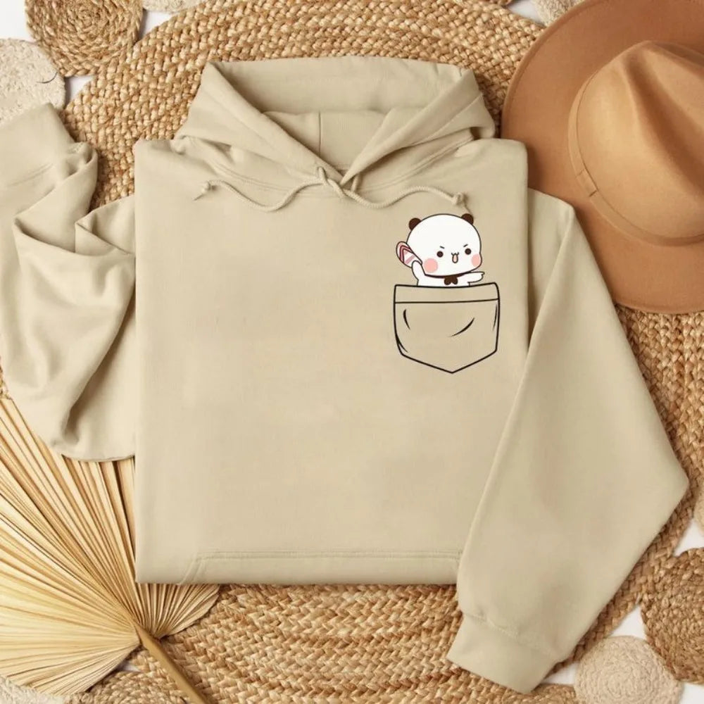 Beige oversized hoodie featuring a cute bear graphic in the pocket, with a cozy fleece material and relaxed fit.