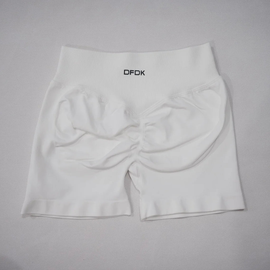White high-waisted seamless gym shorts featuring a scrunch-butt design and an elastic waistband.