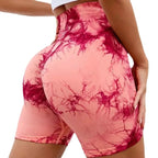 High-waisted gym shorts in pink and burgundy tie-dye, featuring a scrunch design for added lift and comfort.
