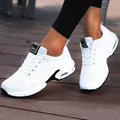 White LOVORA™ Aura Air Boost Platform Sneakers with a breathable mesh upper and black outsole, worn with black leggings.