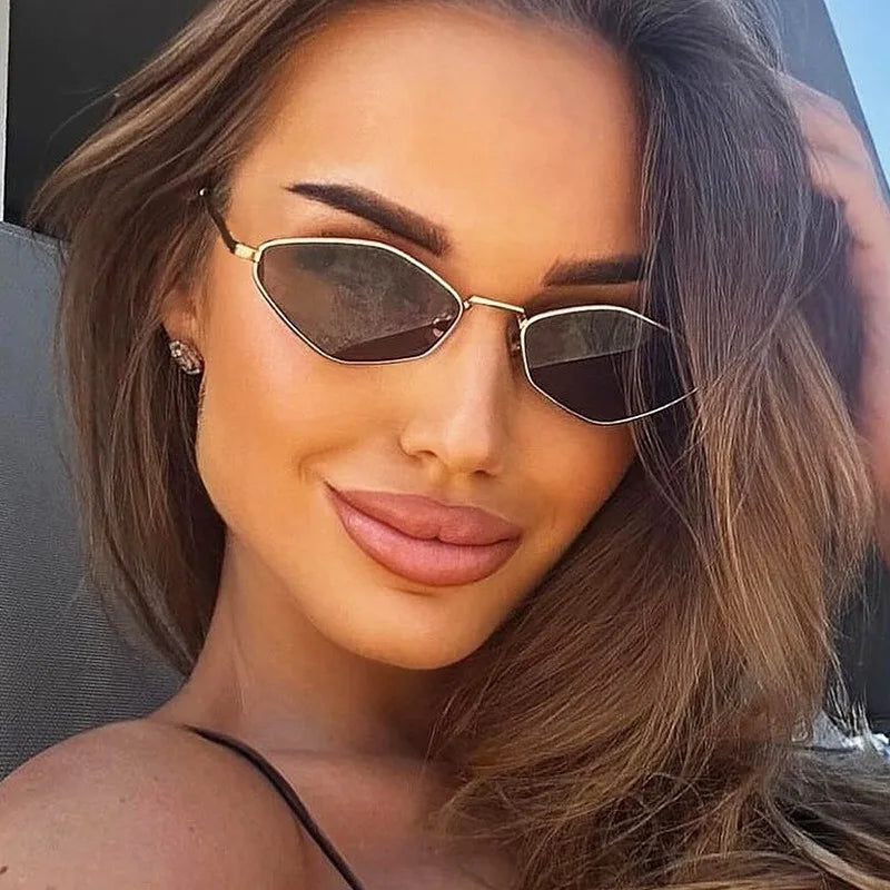 Y2K-inspired polygonal metal sunglasses with diamond-cut lenses, shown on a model with long hair and a smooth complexion.