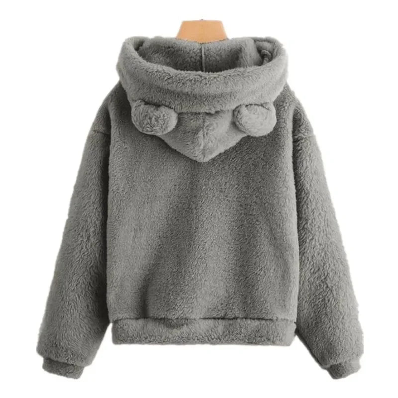Cozy oversized gray teddy hoodie featuring plush ears and a soft fleece texture, designed with drop shoulders and ribbed trims.