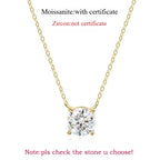 Round-cut Moissanite pendant necklace with yellow gold chain. Minimalist design featuring a secure crown-setting.