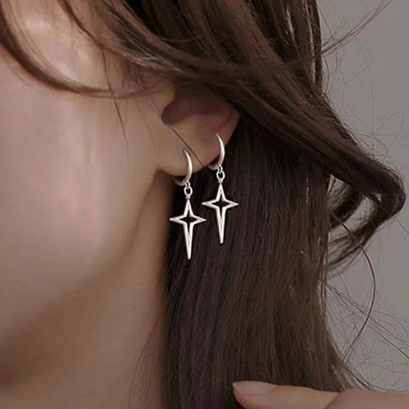 Gothic Cyber-Punk Hollow Star Drop Earrings in dark silver with asymmetrical star designs, hanging elegantly from the earlobe.