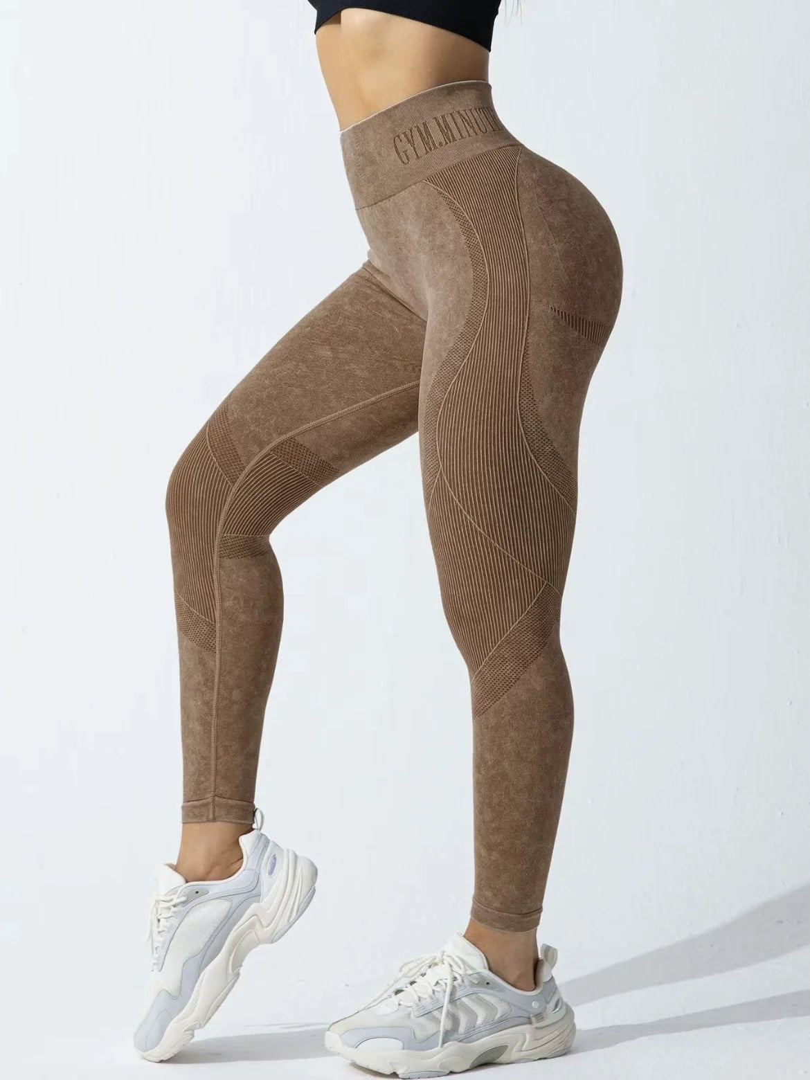 High-waisted, sand-washed leggings in a brown hue with textured seams, paired with white sneakers.