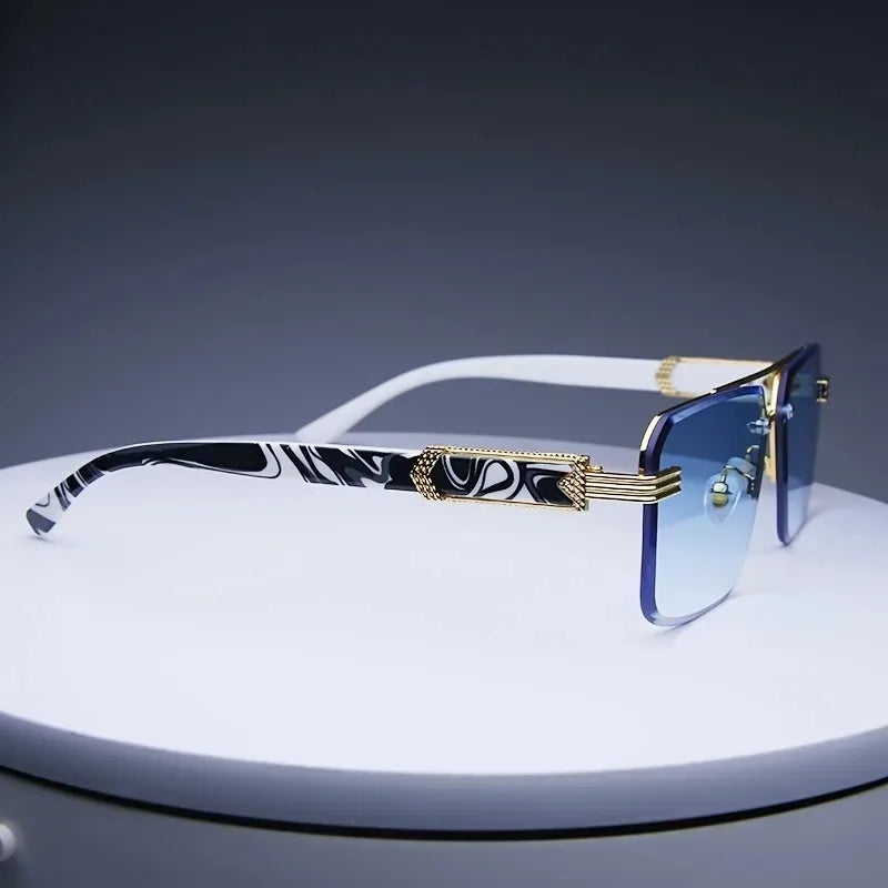 Rimless square sunglasses with gradient blue lenses, gold-tone metallic accents, and stylish black-and-white patterned temples.