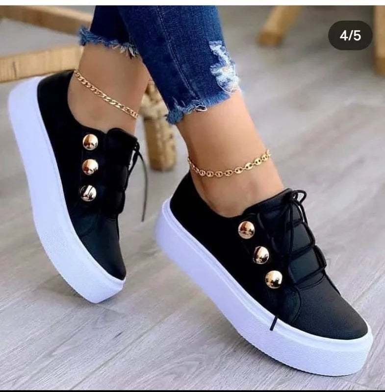 Black LOVORA™ Classic Leather Platform Casual Sneakers featuring a sleek design, white platform sole, and gold decorative buttons.