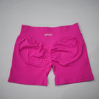Pink seamless high-waisted gym shorts featuring a scrunch-butt design and wide waistband for comfortable fit.
