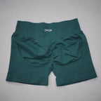 High-waisted teal gym shorts with a seamless design and scrunch butt detail, featuring a wide waistband for comfort.