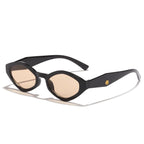 Bold cat-eye sunglasses with a thick black frame and light brown lenses, featuring a sculpted design and curved arms.