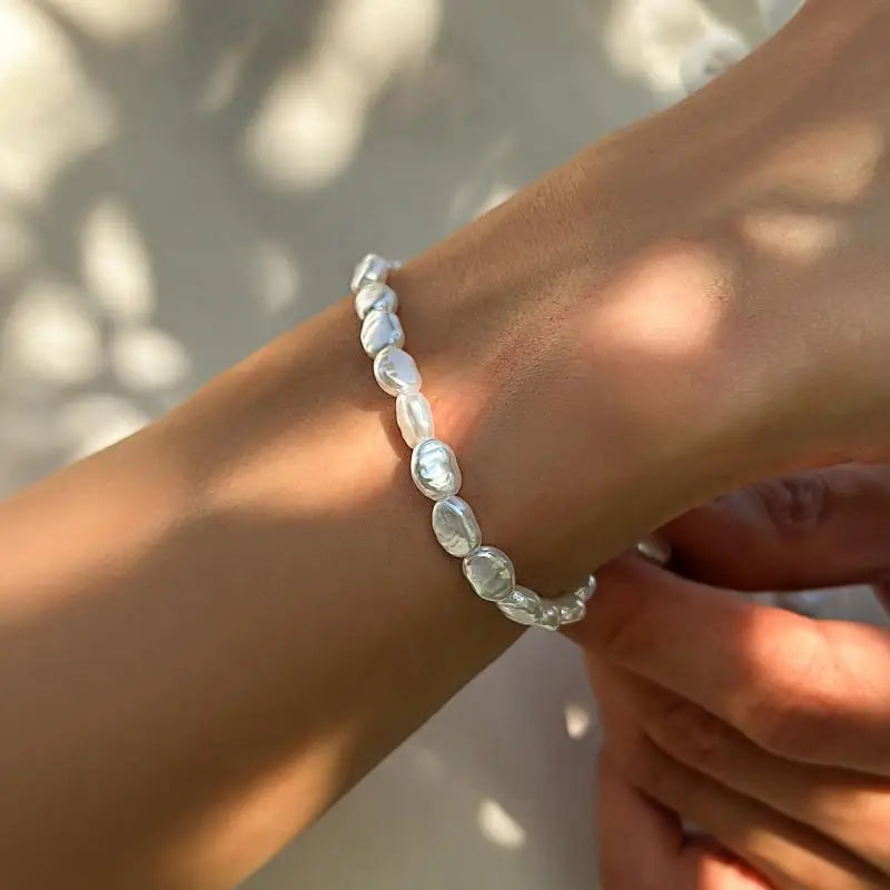 Unisex LOVORA™ Y2K Vintage Pearl & Steel Chain Set bracelet, featuring oval luster pearls on a smooth wrist.