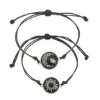 Two minimalist black rope bracelets featuring a sun and moon emblem, with adjustable sliding knots for a custom fit.