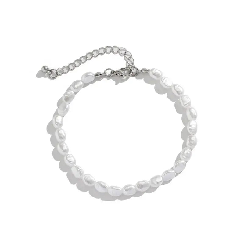 Unisex jewelry set featuring a chain bracelet with round, lustrous white imitation pearls and metallic accents.