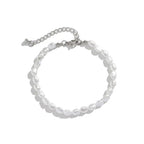 Unisex jewelry set featuring a chain bracelet with round, lustrous white imitation pearls and metallic accents.