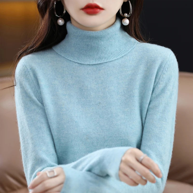 Light blue turtleneck sweater made from merino wool and cashmere, featuring a ribbed collar and relaxed fit.