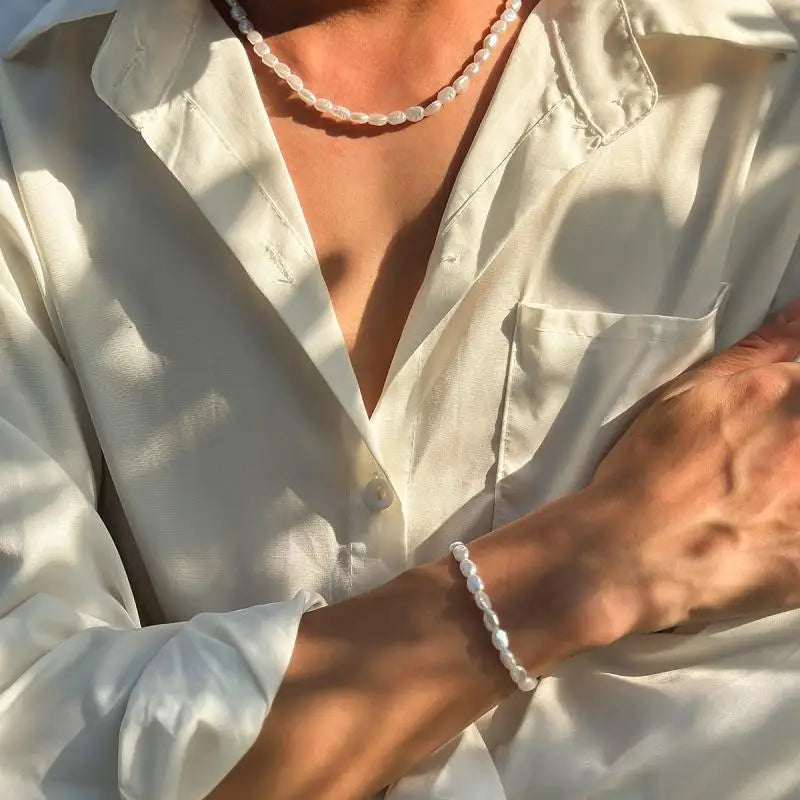 Unisex LOVORA™ Y2K Vintage Pearl & Steel Chain Set worn with a light-colored shirt, featuring oval pearls and a smooth design.