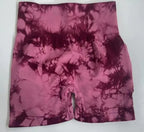 Premium tie-dye high-waisted gym shorts in shades of pink and burgundy, featuring a seamless design and wide waistband.