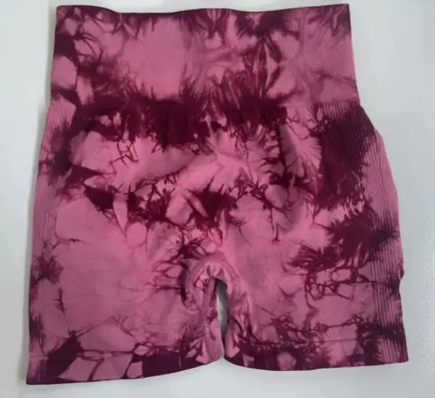 Premium tie-dye high-waisted gym shorts in shades of pink and burgundy, featuring a seamless design and wide waistband.
