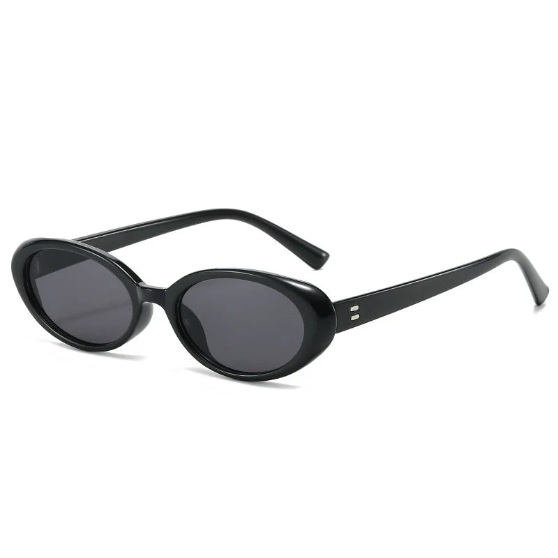Black oval minimalist sunglasses with shatterproof lenses and sleek, high-polish metallic hinges.
