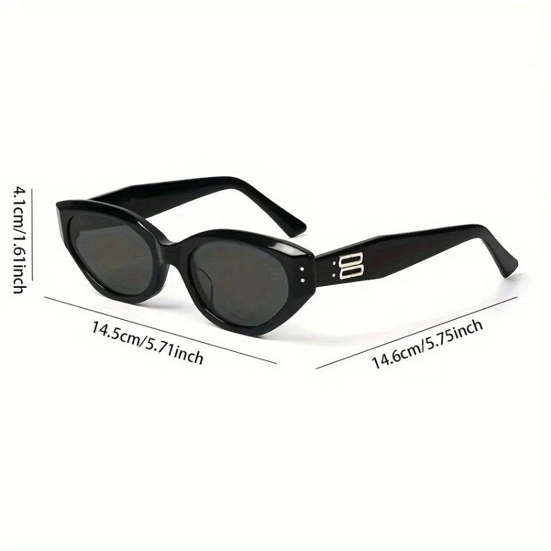 Chunky black cat-eye sunglasses with dark lenses, featuring a sculpted frame and stylish side detailing.