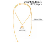 Vintage layered necklace with gold-tone metallic links, featuring a heart pendant and pearl accents.