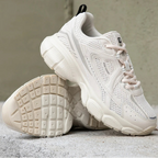 Chunky white and cream sneakers with a breathable mesh design, thick rubber sole, and unique tech-street style.