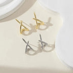 Minimalist cross stud earrings in gold and silver, showcasing a sleek, high-polish design and a lightweight fit.