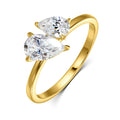 Gold ring featuring two pear-cut Moissanite gemstones, set in an asymmetric design with a smooth band.