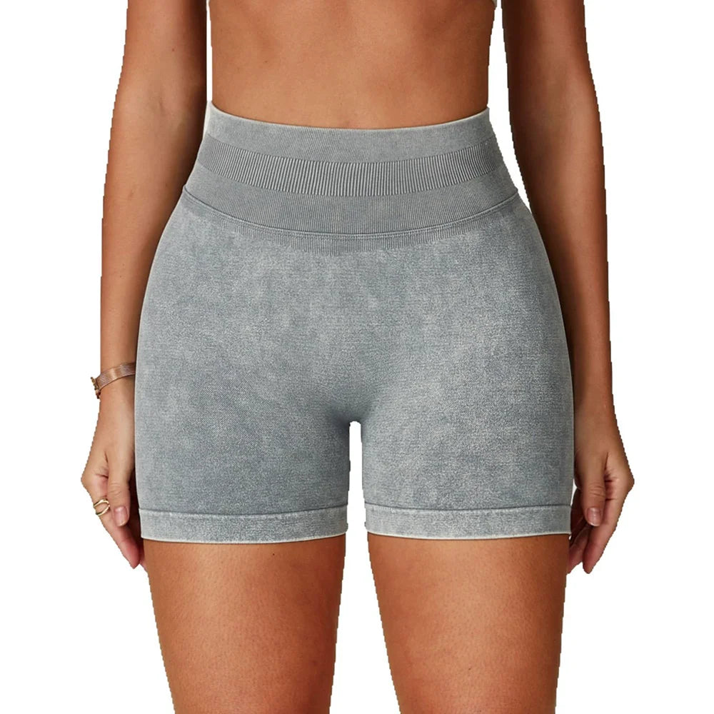 High-waisted, seamless gym shorts in a soft grey sand-washed texture, offering a fitted, sculpting design.