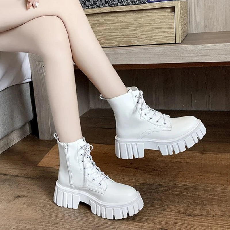 Chunky white LOVORA™ Combat Matrix platform boots with lace-up front and textured sole, worn with bare legs.