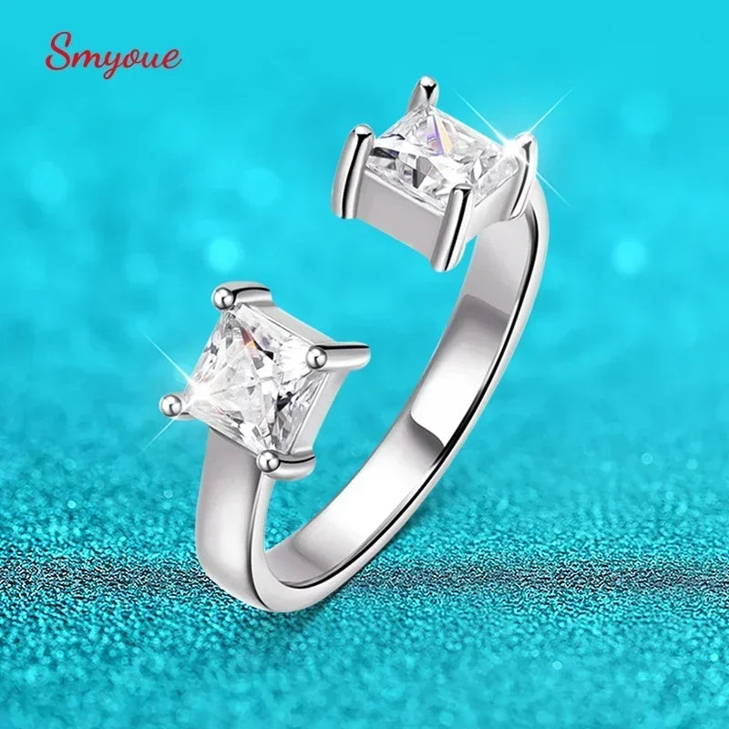 Adjustable LOVORA™ Aura ring featuring two square princess-cut Moissanite stones set in polished silver, reflecting brilliant light.